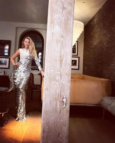 Lively poses in her living room area in a sparkly silver outfit in May 2022Credit: Blake Lively/Instagram