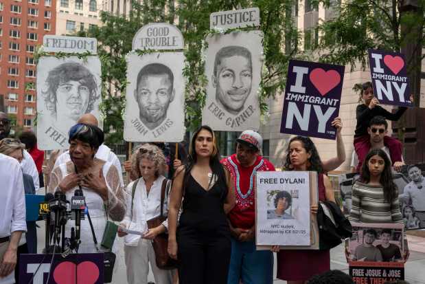 Raiza, center, mother of Dylan Lopez Contreras, first public high school student detained by federal agents, attends a press conference outside the Jacob K. Javits federal building, Thursday, July 17, 2025, in New York.