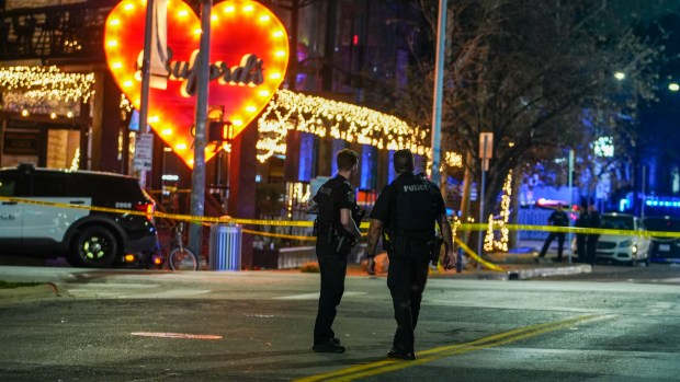 Police officers guard the scene on West 6th Street at West Avenue after a shooting, Sunday March 1, 2026, in Austin, Texas. 