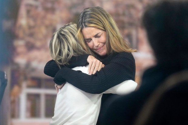Savannah Guthrie hugs Dylan Dreyer during a visit to the Today show at Rockefeller Plaza in New York on Thursday, March 5, 2026. (Photo by Charles Sykes/Invision/AP)