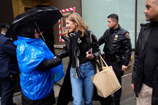 Savannah Guthrie greets a security guard as she leaves the Today show at Rockefeller Plaza on Thursday, March 5, 2026, in New York. (Photo by Charles Sykes/Invision/AP)