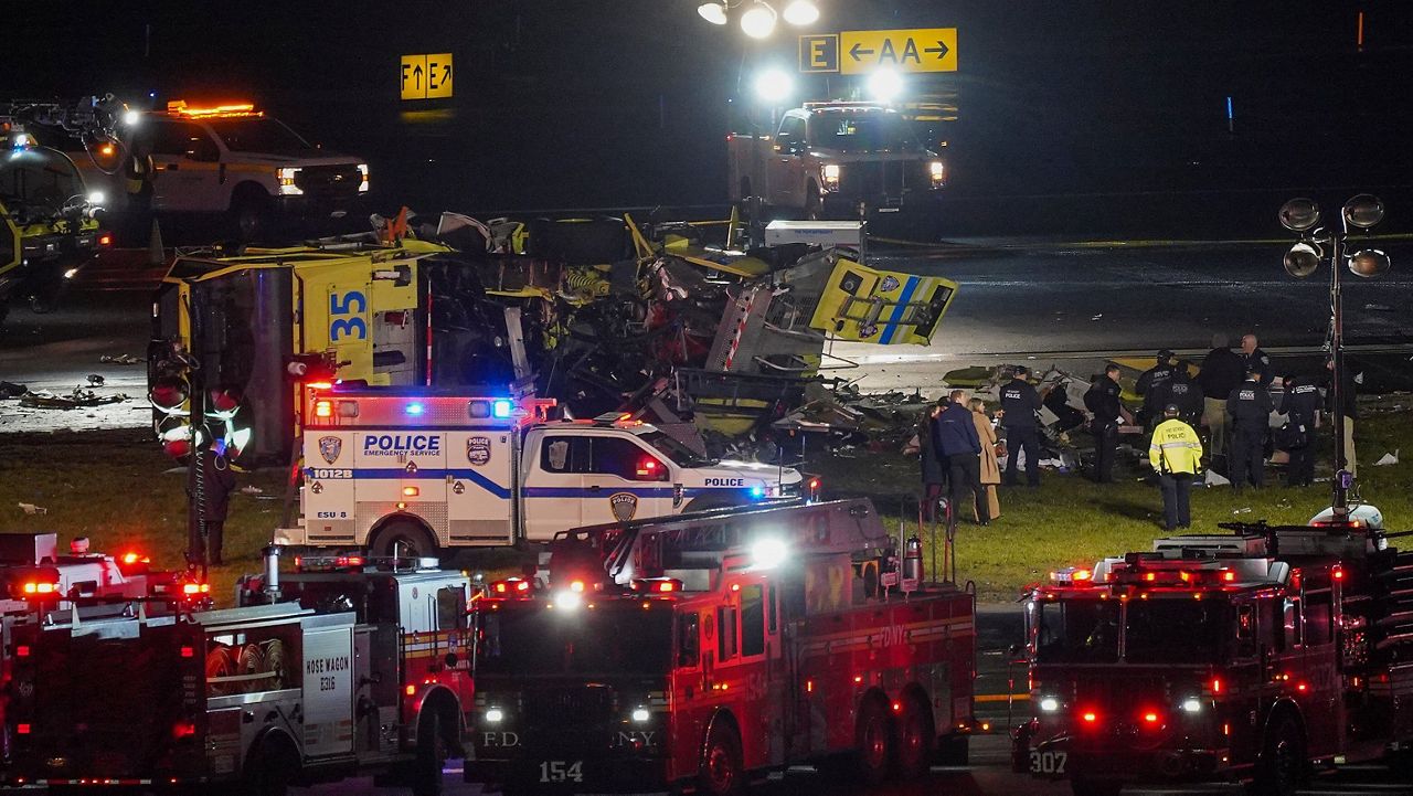 A Port Authority aircraft rescue and firefighting vehicle lays on its side off of runway 4 after colliding with an Air Canada jet after it landed at LaGuardia Airport, Monday, March 23, 2026, in New York. (AP Photo/Ryan Murphy)