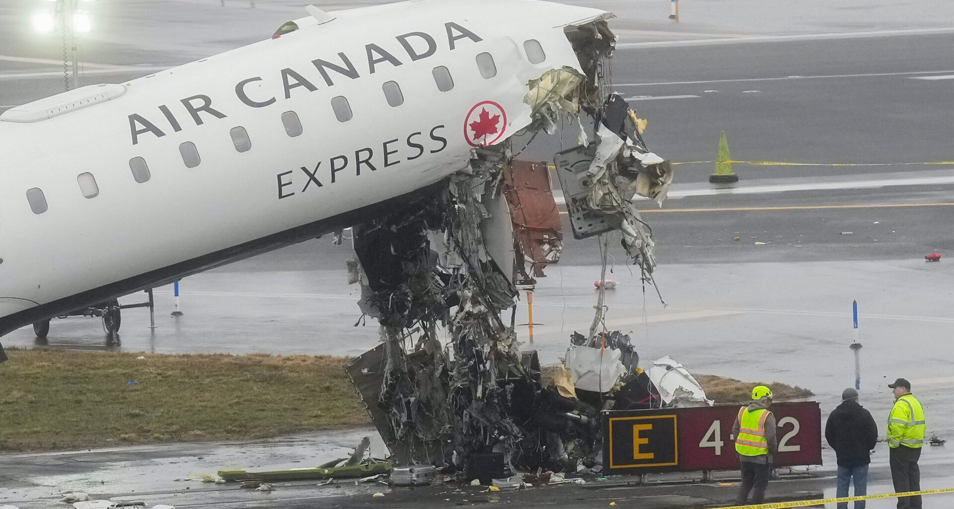 Officials investigate the site, Monday, March 23, 2026, where an Air Canada jet came to rest after colliding with a Port Authority firetruck at LaGuardia Airport, shortly after landing Sunday night in New York. Photo: Seth Wenig/AP