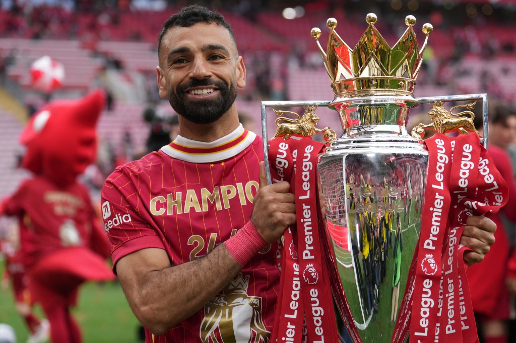 Liverpool's Mohamed Salah poses with the winner's trophy after the English Premier League soccer match between Liverpool and Crystal Palace at the Anfield stadium in Liverpool, England, May 25, 2025. 