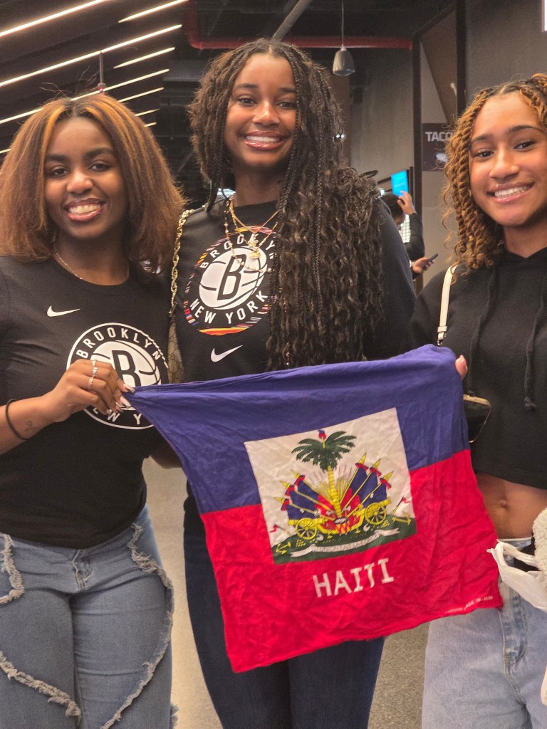 Annabelle and Ari Abelard, left and middle, pose with a friend during the West Indian Carnival-themed night at Barclays Center in Brooklyn on Tuesday, March 10, 2026. Photos by Darlie Gervais for The Haitian Times
