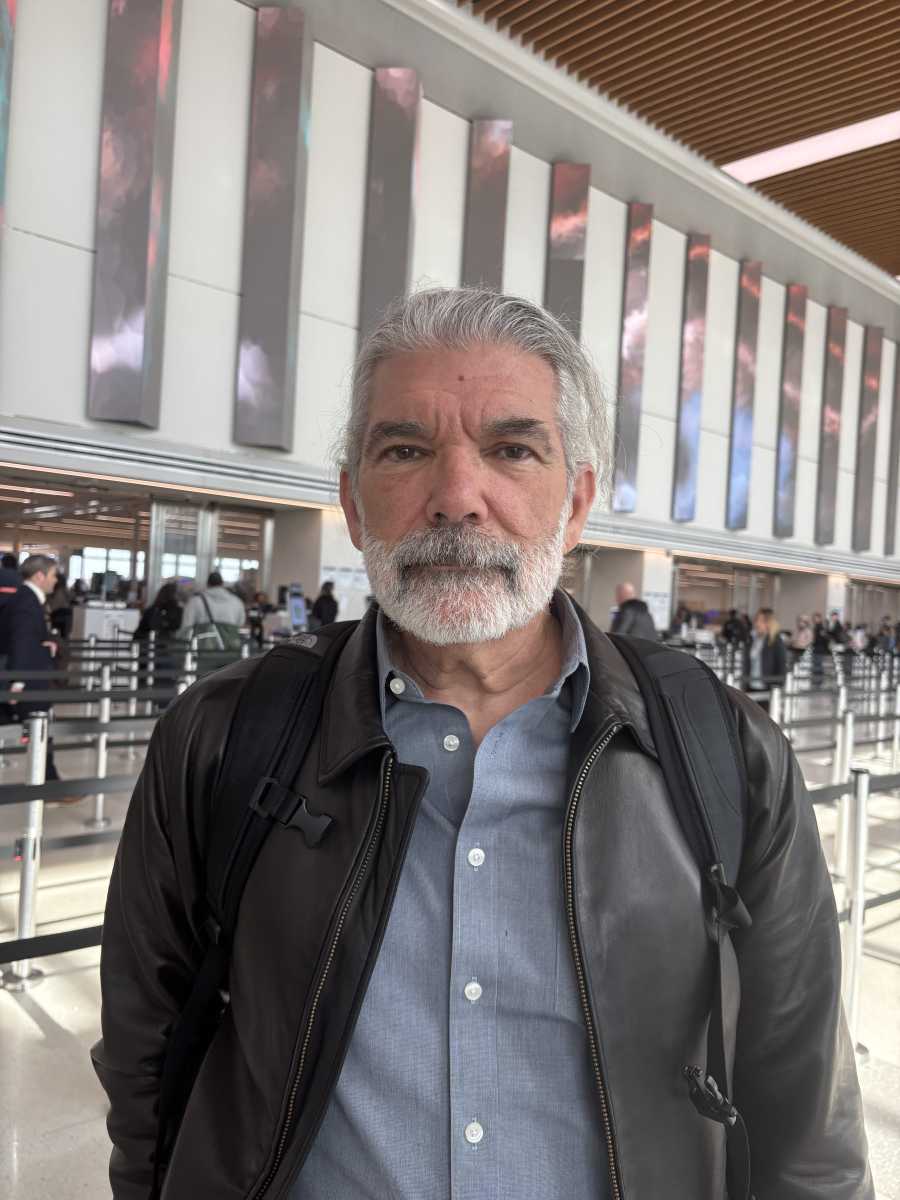 NYC airport traveler in front of airport security line