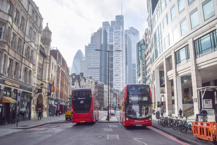 Bishopgate street view showcasing bustling city life with pedestrians, historic architecture, and modern businesses
