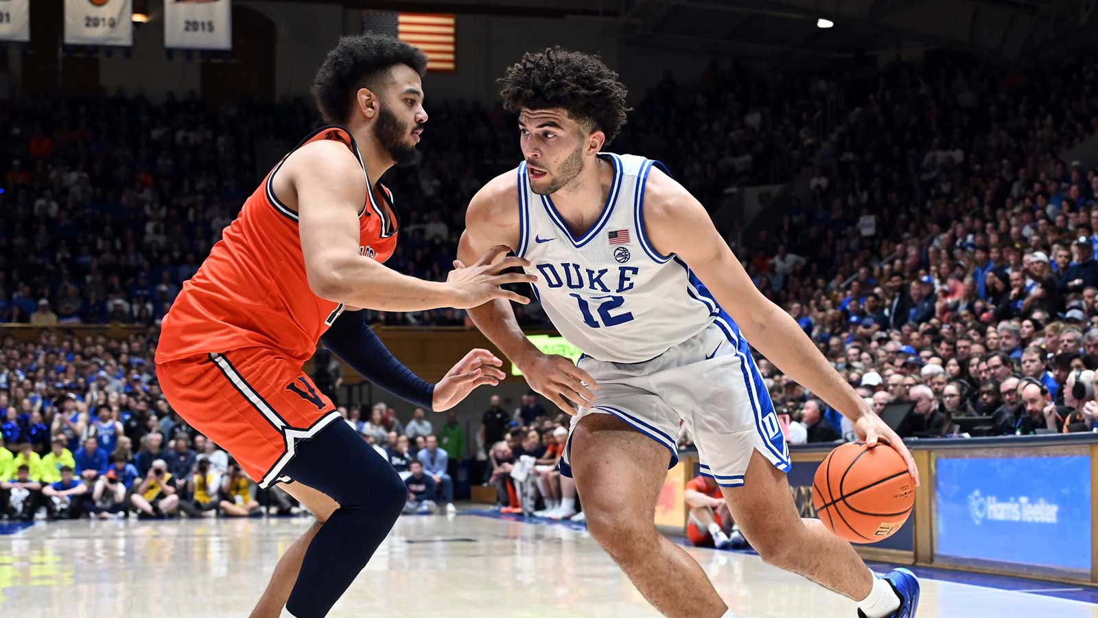 Duke Blue Devils forward Cameron Boozer (12) drives to the basket as Virginia Cavaliers forward Devin Tillis (11) defends during the second half at Cameron Indoor Stadium. Duke won 77-51.