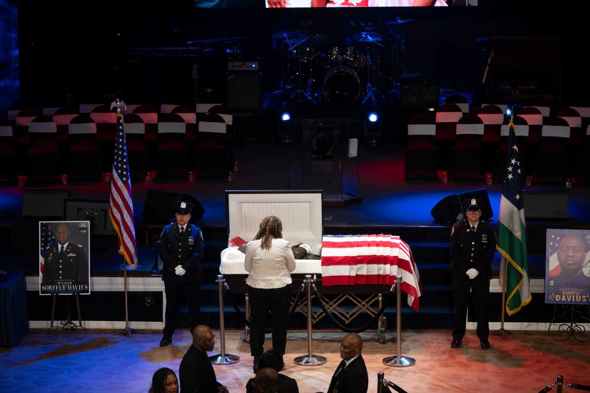Mourner views the body of Major Sorffly Davius