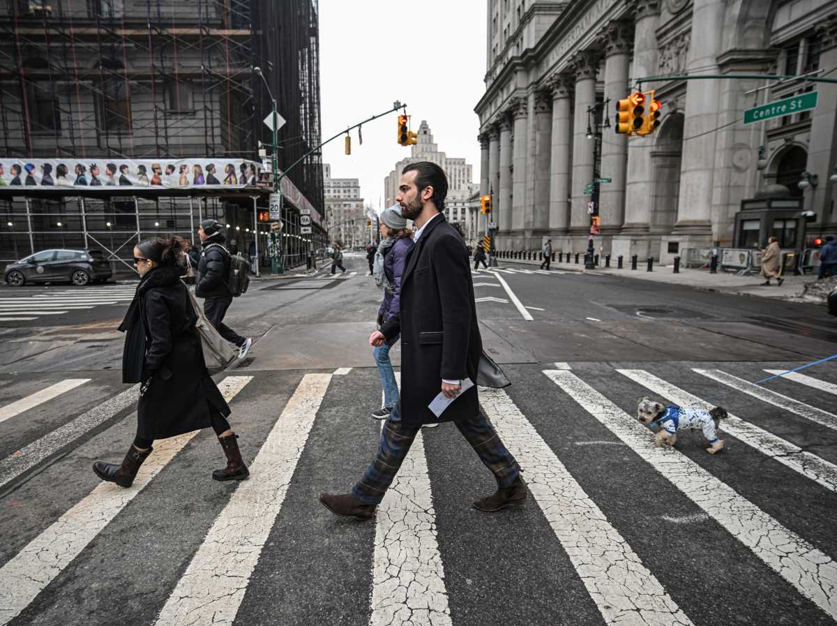 people walking through a crosswalk