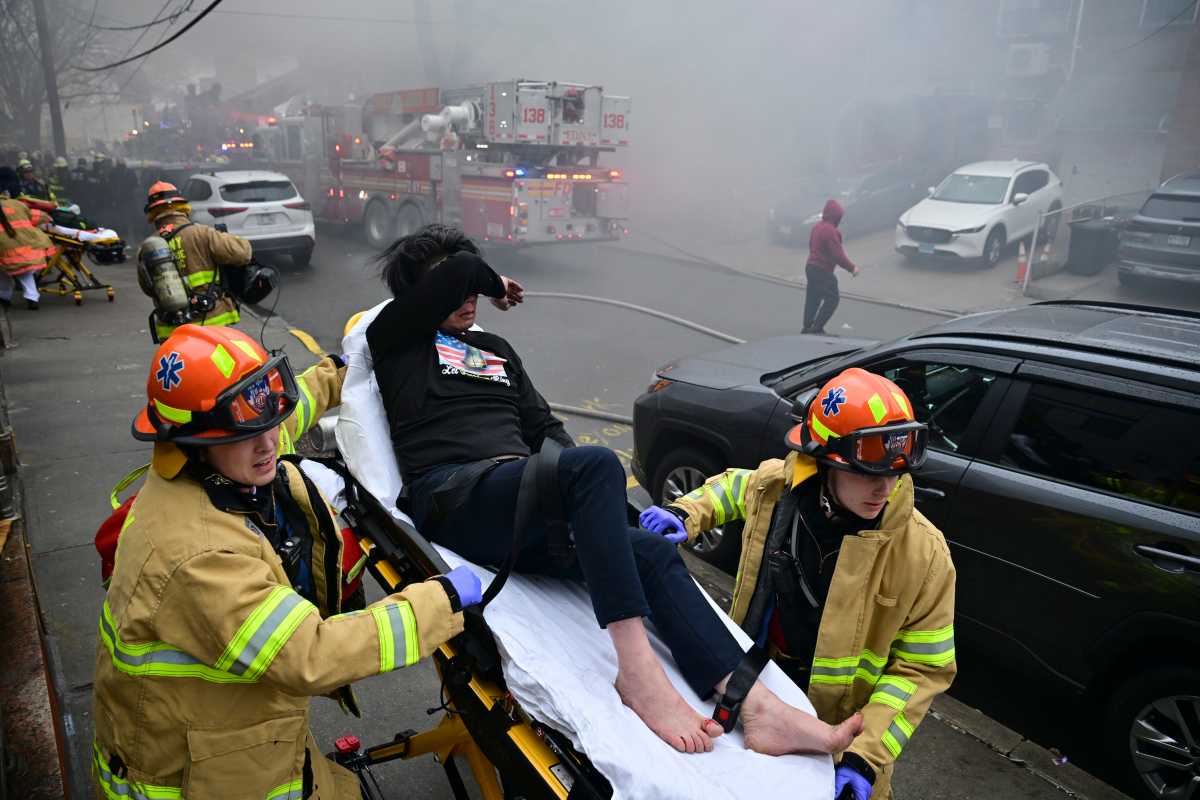 Authorities say three people are dead, including a child, after a four-alarm fire tore through a multi-family residence in Flushing on Monday, March 16.
