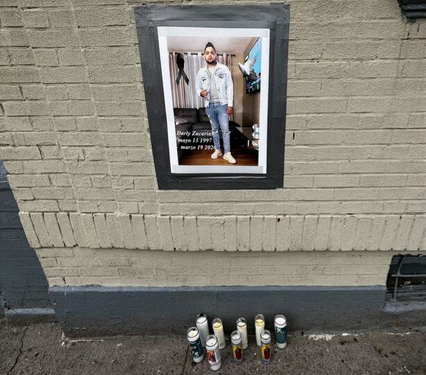 A memorial to Darlyn Zacarias outside the Harlem apartment building he lived in. He was fatally struck while working as an e-bike delivery person in Harlem on Thursday. (Julian Roberts-Grmela / NY Daily News)