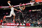 Portland Trail Blazers forward Toumani Camara (33) defends Brooklyn Nets forward Chaney Johnson during the first half of an NBA basketball game Monday, March 23, 2026, in Portland, Ore.
