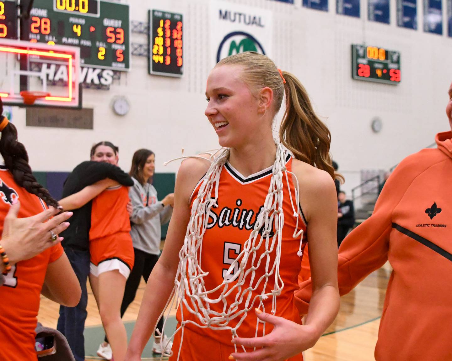 St. Charles East's Brooklyn Schilb (5) is all smiles while wearing the 4A Sectional championship game net around her neck after taking the win over Glenbard West on Thursday Feb. 26, 2026, held at Bartlett High School.