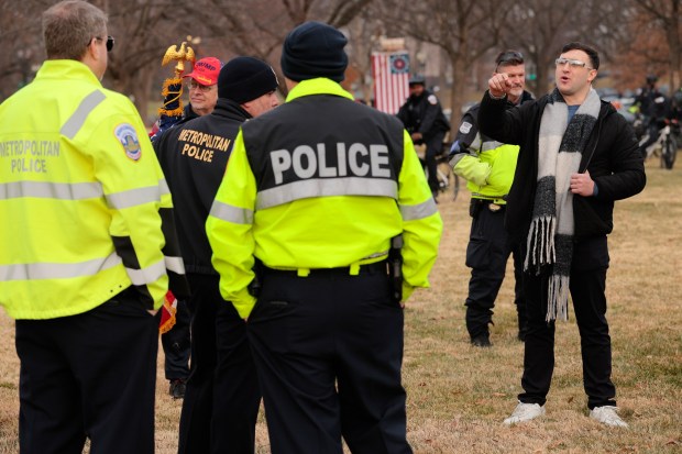 Jake Lang (R), who was charged with eight counts of assaulting officers before his pardon, threatens a D.C. Metropolitan Police officer, including Commander Jason Bagshaw (L), during a January 6th rally and memorial march marking five years since the attack on Jan. 6, 2026 in Washington, DC. (Photo by Chip Somodevilla/Getty Images)
