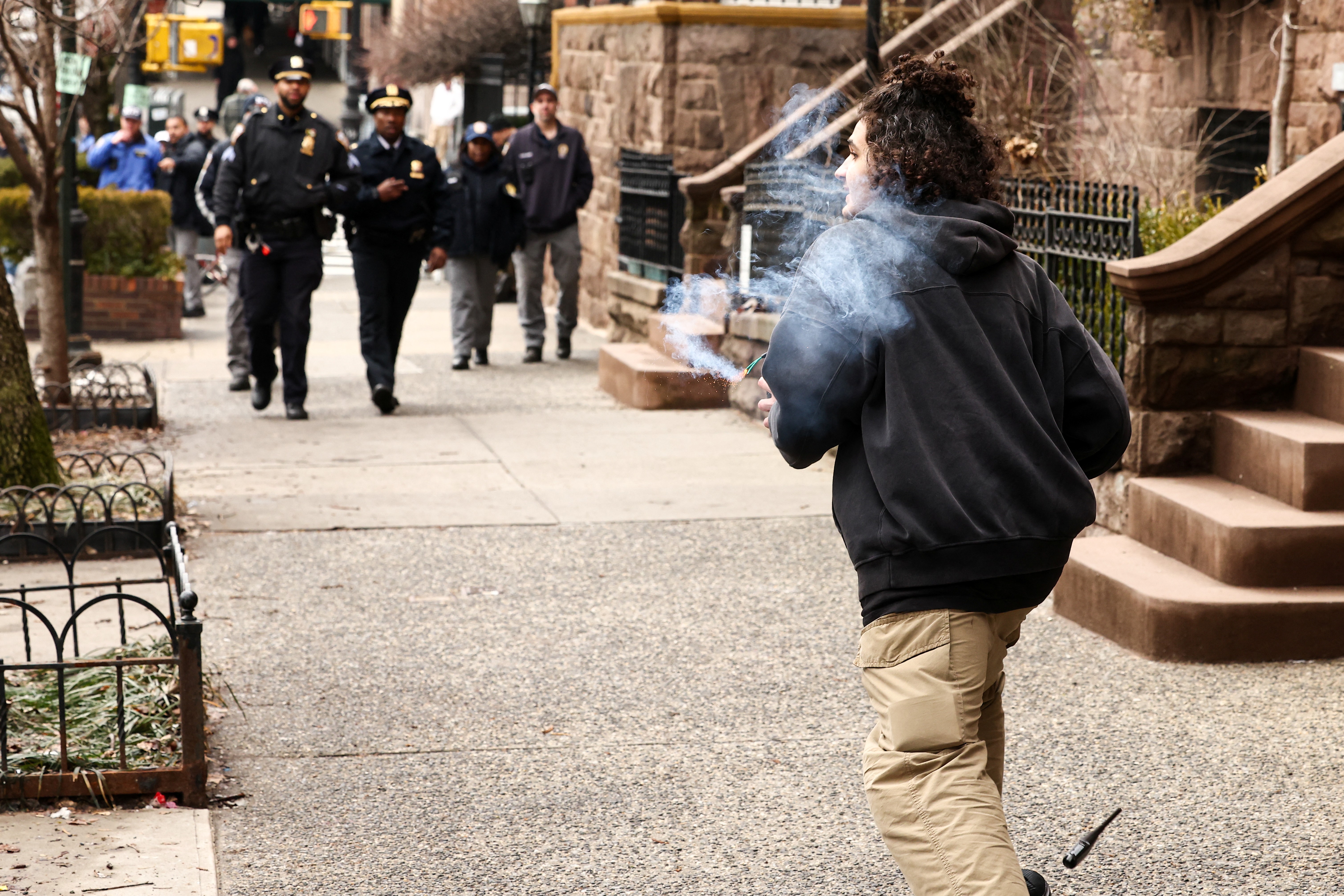 A left-wing activist carries a homemade device during a protest...
