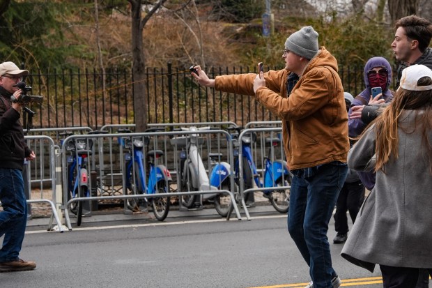 A man pepper-sprays left-wing activists while being chased at a protest organized by right-wing influencer Jake Lang on March 7, 2026 in New York City. (Photo by Ryan Murphy/Getty Images)