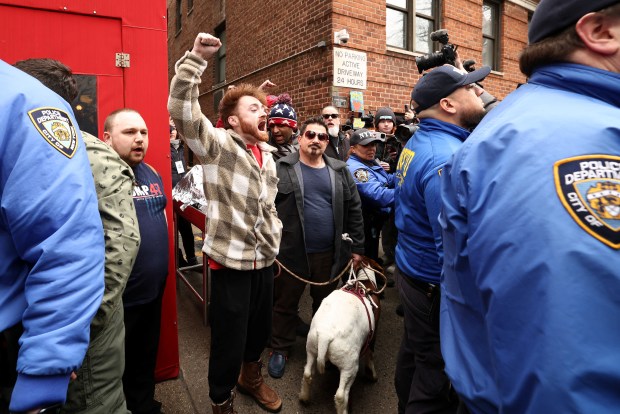 A man holds a goat on a leash during a protest organized by far-right influencer Jake Lang against alleged "Islamification" and to ask for a "stop of public Muslim prayer" in New York, in front of Gracie Mansion, New York mayor Zohran Mamdani's official residence, in New York on March 7, 2026. (Photo by CHARLY TRIBALLEAU / AFP via Getty Images)