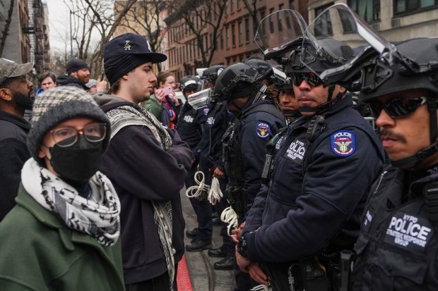 Left-wing activists stand off with New York Police Department officers at a protest organized by right-wing influencer Jake Lang on March 7, 2026 in New York City. (Photo by Ryan Murphy/Getty Images)