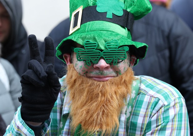 A person watches the annual St. Patrick's Day Parade in New York on March 17, 2026. (Photo by TIMOTHY A. CLARY / AFP via Getty Images)