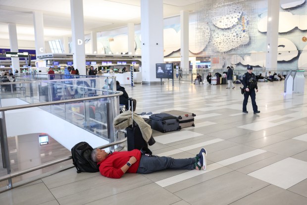 Travelers wait at Terminal B in LaGuardia Airport after flights were canceled on Monday. 