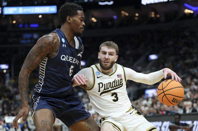 Braden Smith (3) of Purdue works toward the basket against Avantae Parker of Queens University during the first half of the teams’ first-round NCAA Men’s Tournament game at Enterprise Center on March 20, 2026 in St Louis, Missouri.