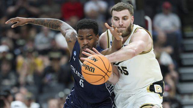 Oscar Cluff (45) of Purdue and Avantae Parker of Queens University battle for the ball during the first half of the teams’ first-round NCAA Men’s Tournament game at Enterprise Center on March 20, 2026 in St Louis, Missouri. Oscar Cluff (45) of Purdue and Avantae Parker of Queens University battle for the ball during the first half of the teams’ first-round NCAA Men’s Tournament game at Enterprise Center on March 20, 2026 in St Louis, Missouri.