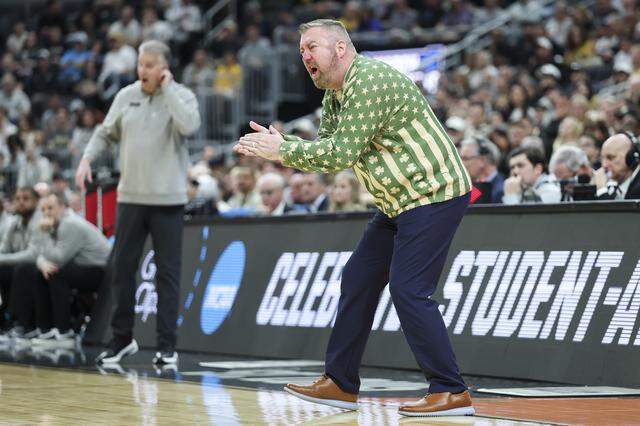Queens University Head Coach Grant Leonard claps for his team during a NCAA Men’s Basketball Tournament first-round game against Purdue at Enterprise Center on March 20, 2026 in St Louis, Missouri.