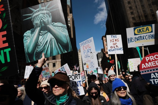 NEW YORK CITY - MARCH 28: Protesters hold signs as they participate in a 'No Kings' protest in Manhattan on March 28, 2026 in New York City. This is the third nationwide "No Kings" protest held against the Trump administration. (Photo by Spencer Platt/Getty Images)