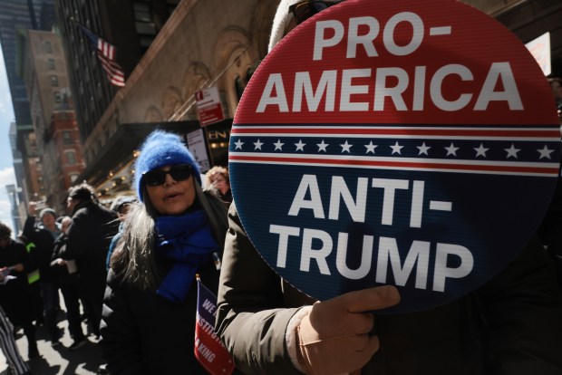 NEW YORK CITY - MARCH 28: Protesters hold signs as they participate in a 'No Kings' protest in Manhattan on March 28, 2026 in New York City. This is the third nationwide "No Kings" protest held against the Trump administration. (Photo by Spencer Platt/Getty Images)