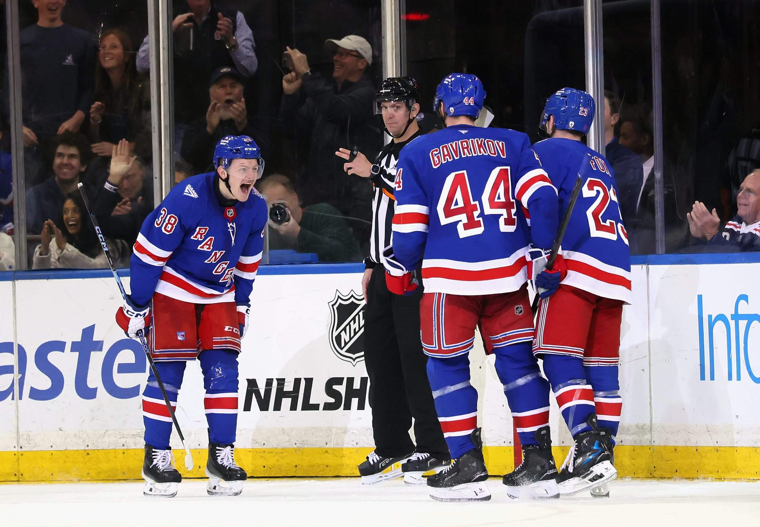 Adam Sykora roars in excitement at two Rangers teammates after scoring.