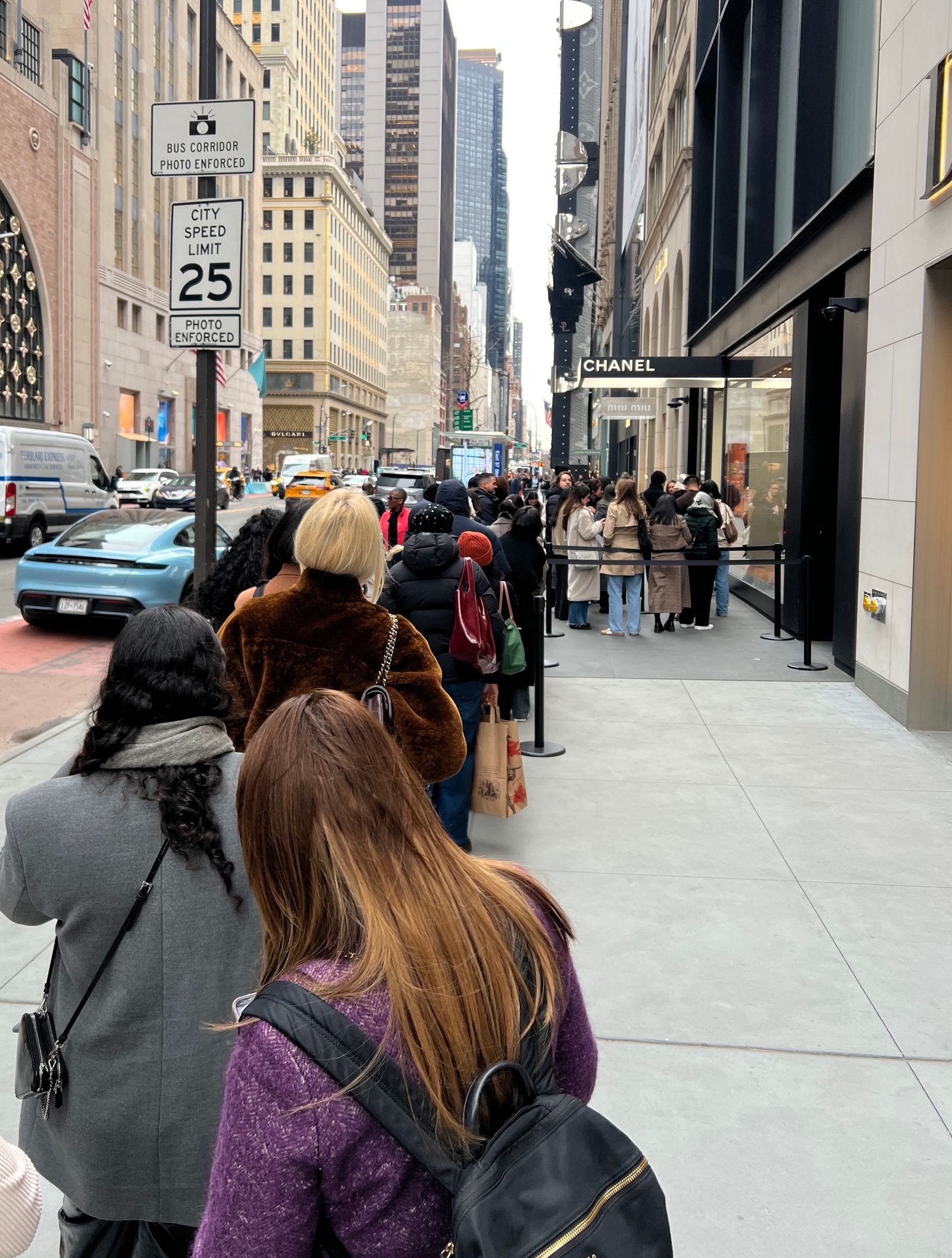 Image may contain Adult Person City Road Street Urban Accessories Bag Handbag Car Transportation and Vehicle