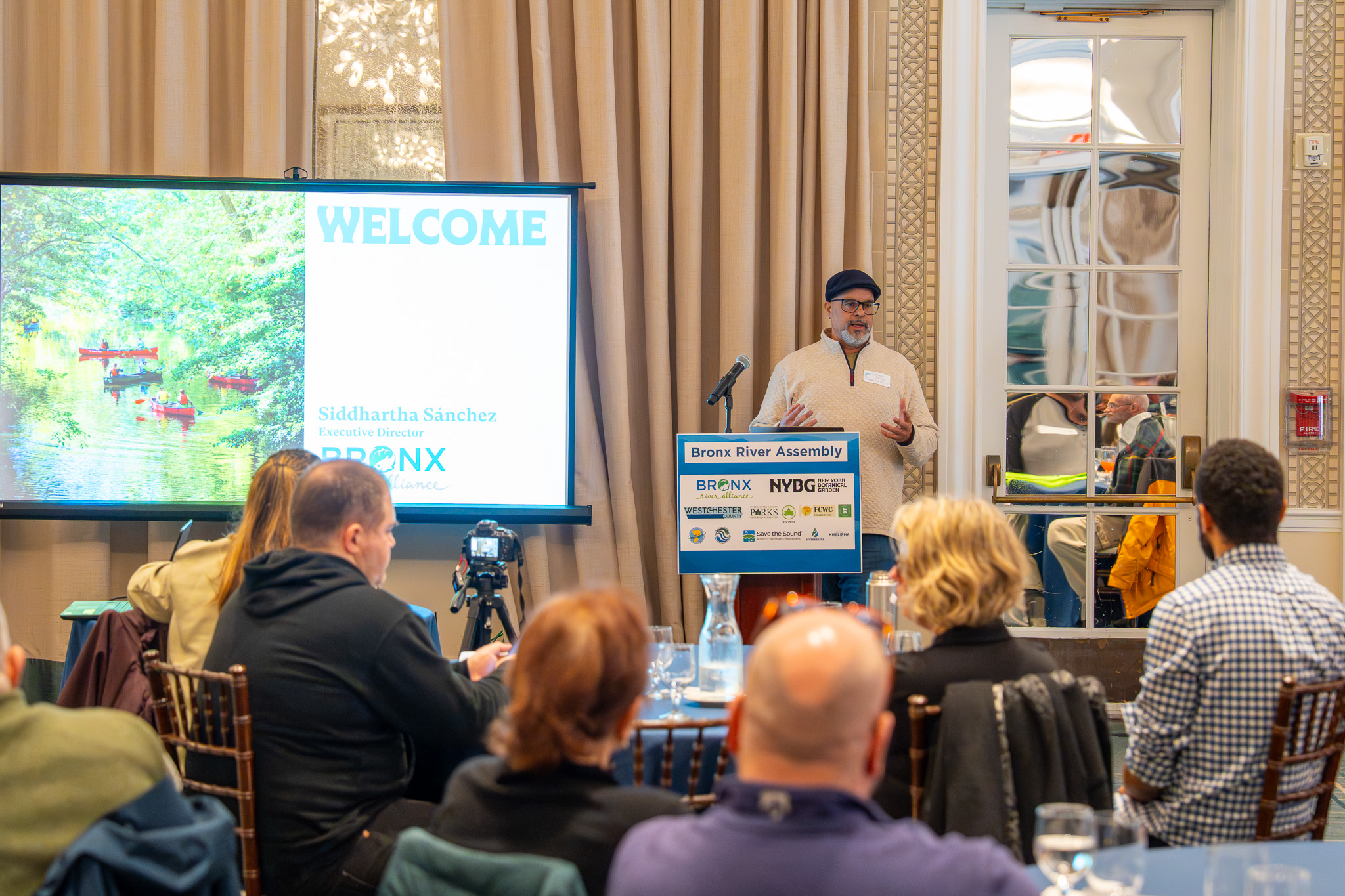 A man stands at a podium in front of a crowd.