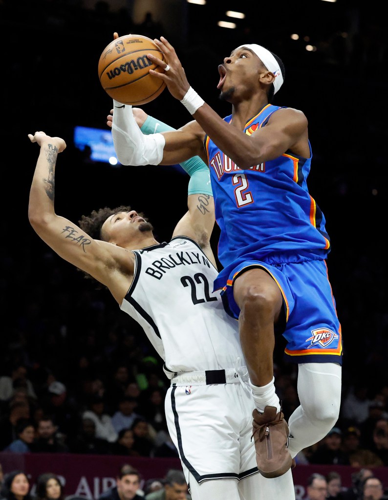 Oklahoma City Thunder guard Shai Gilgeous-Alexander looks to put up a shot past a defending Brooklyn Nets forward Jalen Wilson during the first half at the Barclays Center in New York, New York, USA, Sunday, March 18, 2026. 