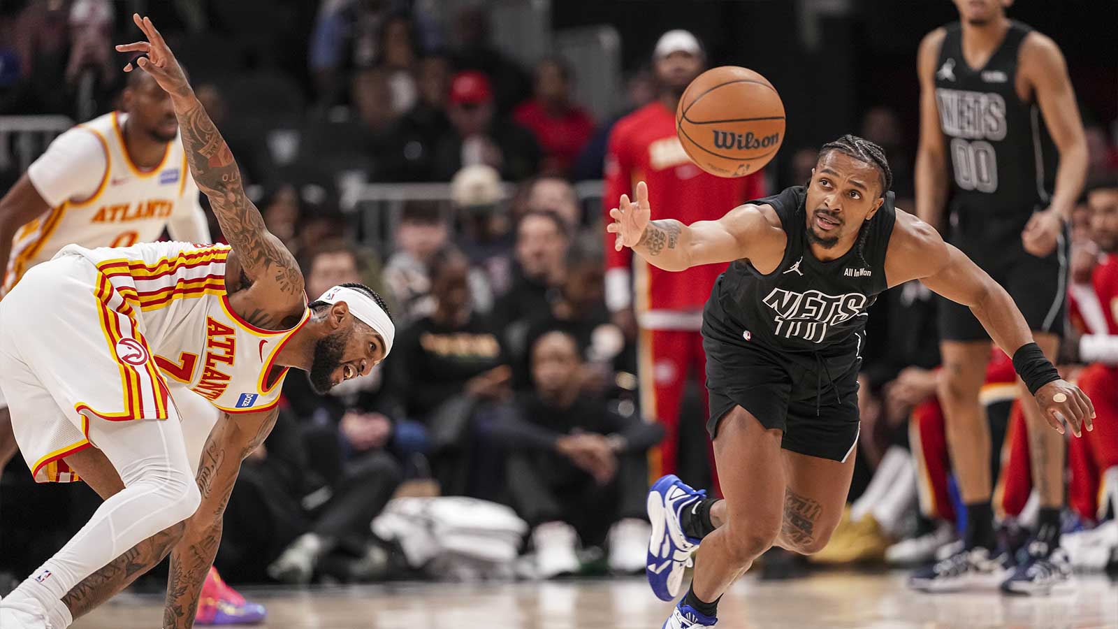 Brooklyn Nets guard Tyson Etienne (10) chases the ball after it was knocked away from him by Atlanta Hawks guard Nickeil Alexander-Walker (7) during the second half at State Farm Arena.