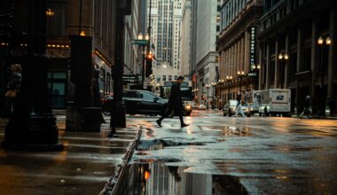 New York City street with pedestrian walking and cars driving by