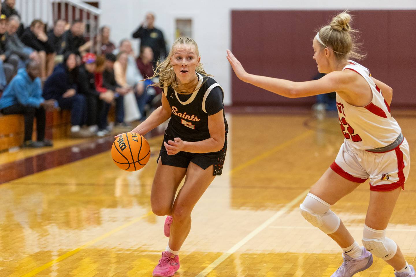 St. Charles East's Brooklyn Schilb drives the baseline against Benet's Bridget Rifenburg at the Montini Christmas Tournament on Tuesday, Dec.23,2025 in Lombard.