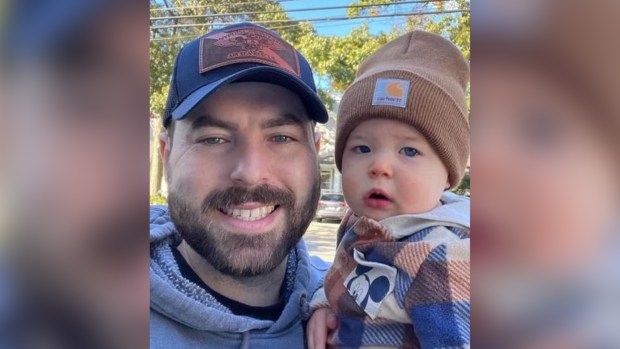 Officer Jonathan Diller with his child. (NYC PBA)