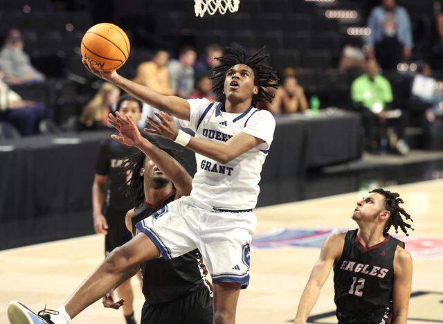 Queen’s Grant’s Mehki Allen, center, splits the Warren County defense for two-points during the NCHSAA 2A boys’ championship game at Lawrence Joel Veterans Coliseum in Winston-Salem, NC on Thursday, March 12, 2026. Queen’s Grant defeated Warren County 77-43.