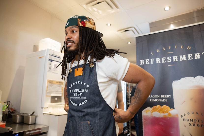Keith Lee, influencer, food critic and Dallas resident, puts on an apron during an...