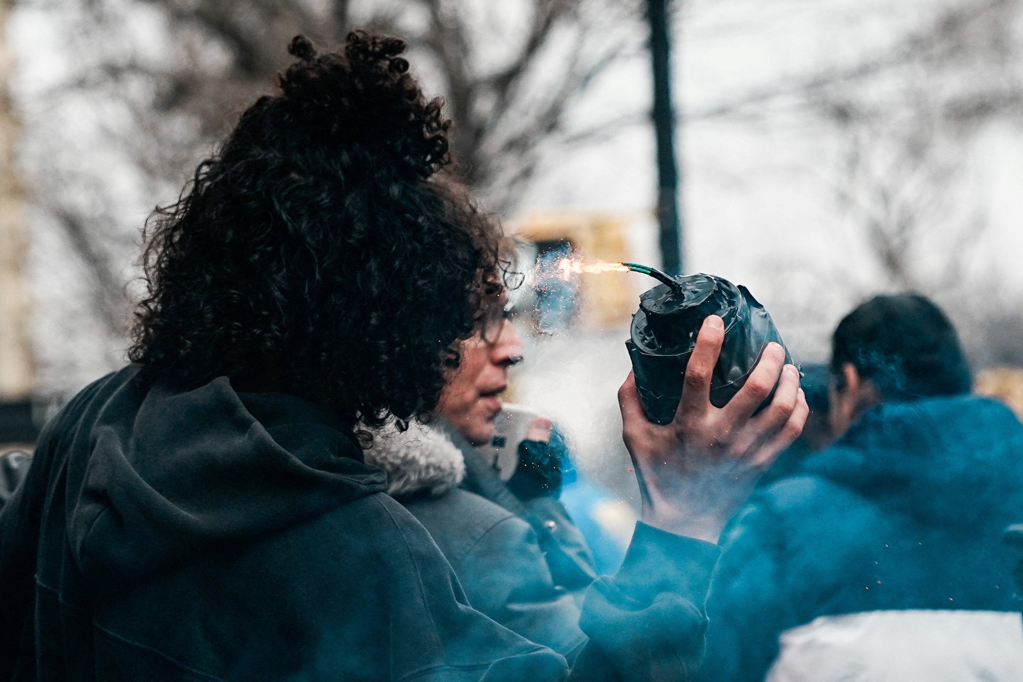 A man is seen throwing an improvised explosive device during protests in New York City on March 7. Emir Balat and Ibrahim Kayumi were arrested immediately after the alleged attack