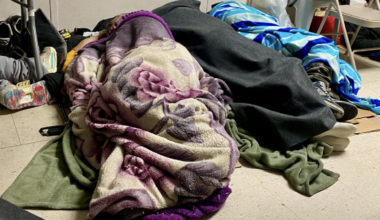 On Friday, February 6, people seeking warmth sleep on the floor of a trailer at Elmhurst Hospital. (Credit: A. Felix)