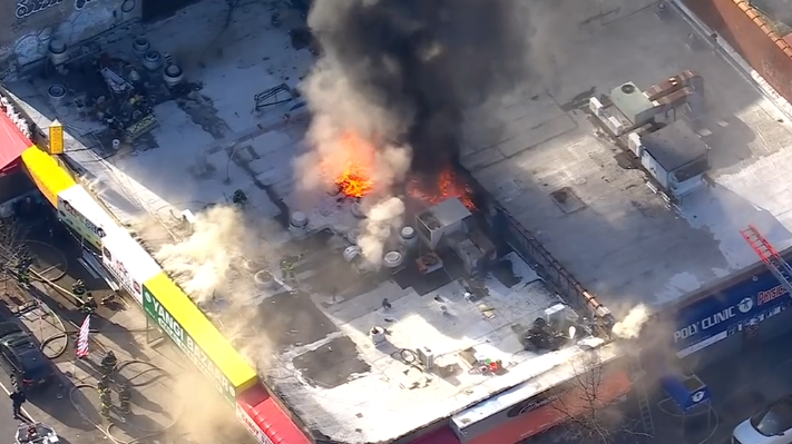 Fire tears through building housing row of businesses in Brooklyn