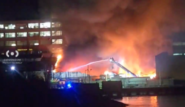 Two firefighters were injured early Wednesday as the FDNY battled a five-alarm fire at factory buildings on the Brooklyn waterfront