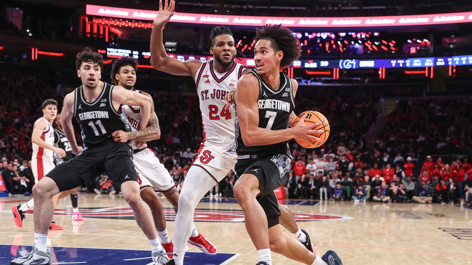 Georgetown Hoyas forward Isaiah Abraham (7) drives past St. John's Red Storm forward Zuby Ejiofor (24) in the first half at Madison Square Garden.