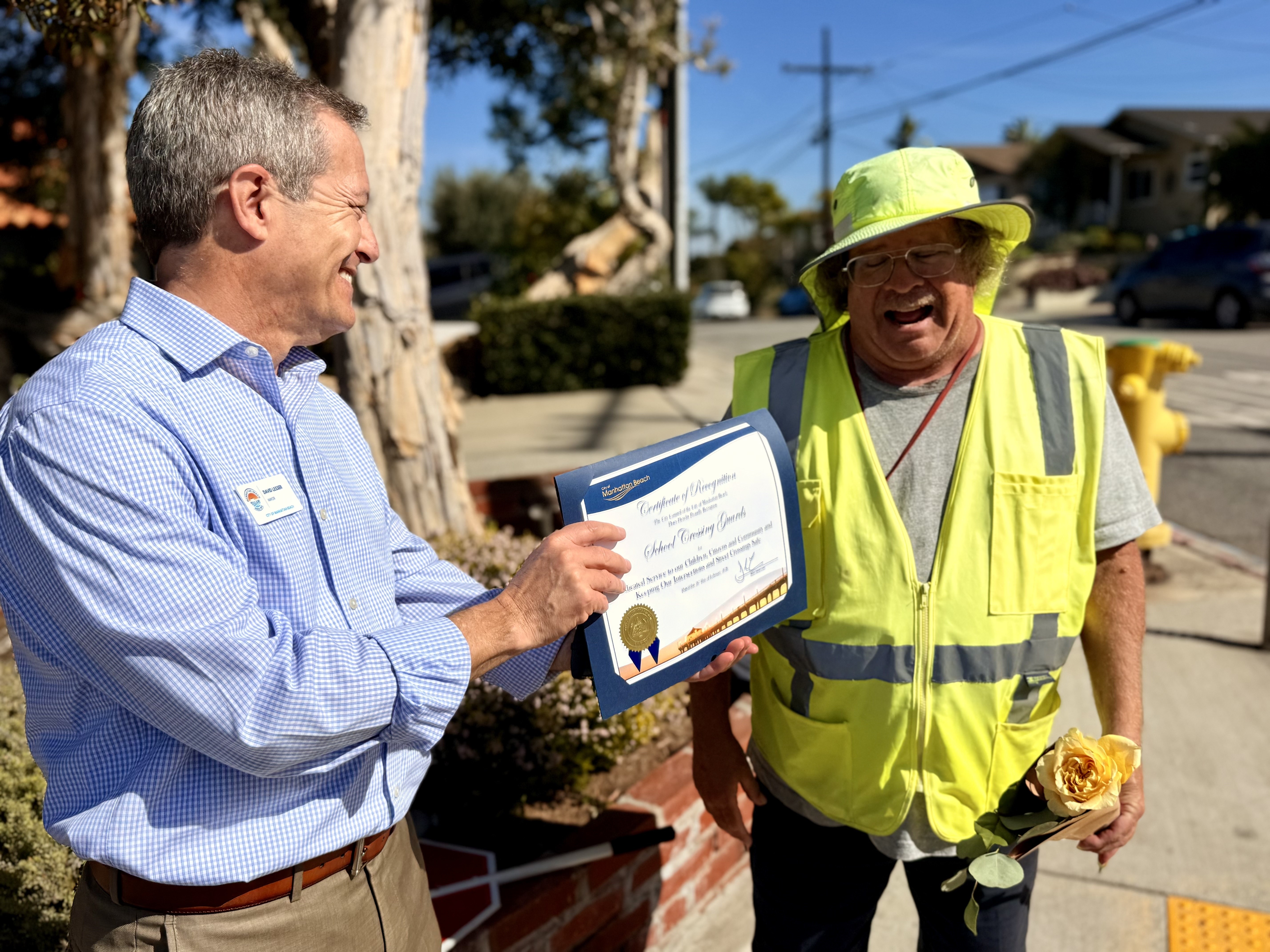 Pennekamp crossing guard Ron Lysik receives a certificate from Manhattan...
