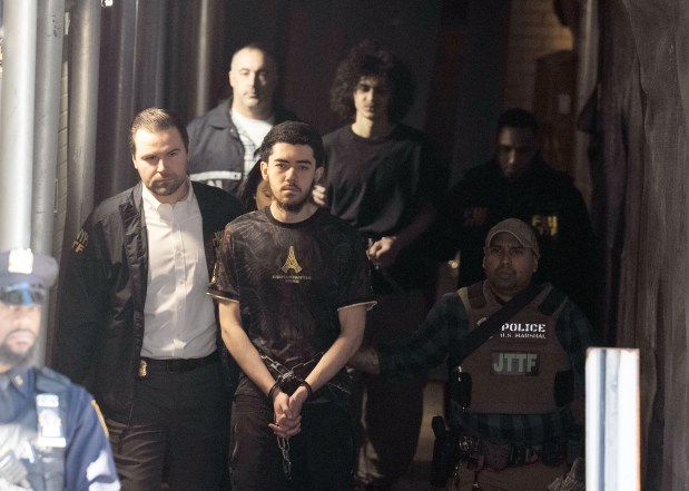 Ibrahim Kayumi (front, center) and Emir Balat (background, center), the two suspects in an attempted bombing during a protest near Gracie Mansion, are pictured in federal custody leaving the NYPD's 26th Precinct stationhouse in Manhattan on Monday, March 9, 2026. (Barry Williams/ New York Daily News)