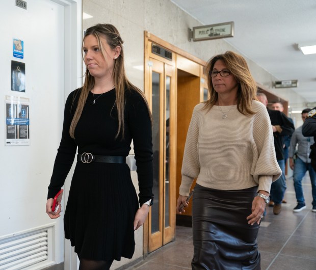 Stephanie Diller (left), the widow of NYPD Officer Jonathan Diller, leaves the courtroom during a break in the murder trial of her husband's accused killer, Guy Rivera, Tuesday, March 10, 2026 in Queens, New York. (Barry Williams/ New York Daily News)
