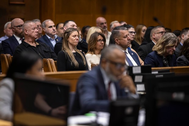 Stephanie Diller, center, the widow of NYPD Officer Jonathan Diller, listens to opening statements during the trial of Guy Rivera, who is charged with the murder of Officer Diller, at Queens Criminal Court on March 10, 2026. (Dave Sanders/Pool/The New York Times)