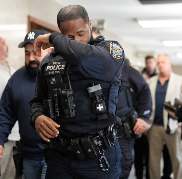 An NYPD officer wipes away a tear leaving the murder trial of Guy Rivera on Tuesday, March 10, 2026, in Queens, New York. Rivera is accused of killing NYPD officer Jonathan Diller in 2024. (Barry Williams/ New York Daily News)